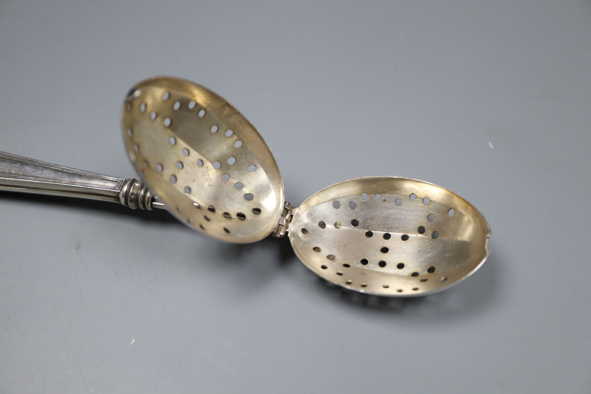 An 830s pastry tongs, a knife, a cased set of six bean end coffee spoons and an infuser.